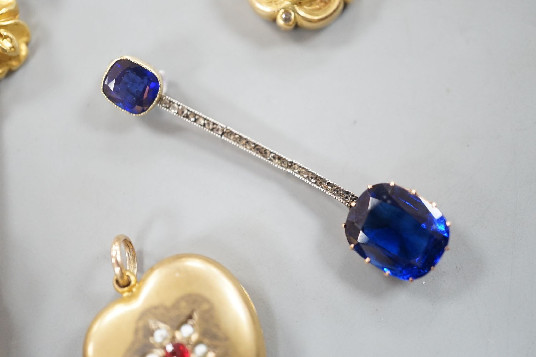 A pair of yellow metal drop earrings, overall 89mm, a simulated sapphire pendant and two other pendants.